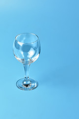 Empty wine glass on blue background	