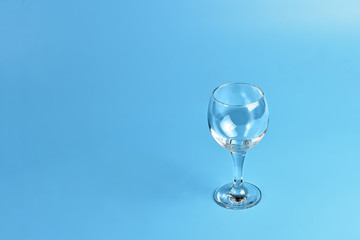 Empty wine glass on blue background	