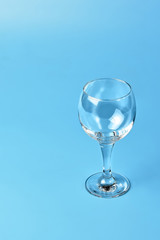 Empty wine glass on blue background	