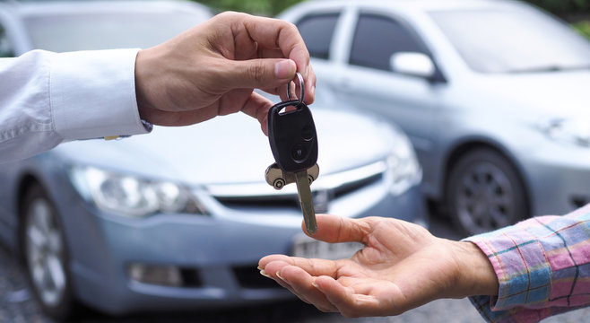 The car salesman and the key to the new owner. - a car key chain link link link link link link li