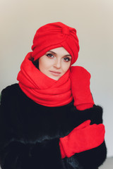Photo of self assured Arabian lady in hijab, shows you right way, points at blank space with both...