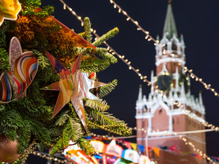 Decorative star on Christmas tree. New Year fair on Red square in Moscow. Spasskaya tower of Kremlin on background. Russia.