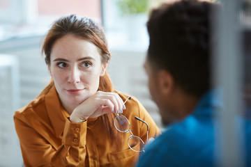Young businesswoman talking to the young man during business interview at office
