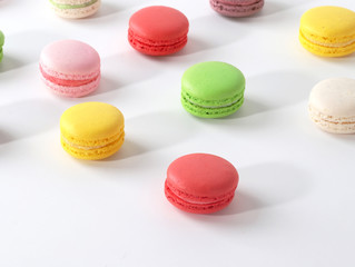 Colored macarons on white background
