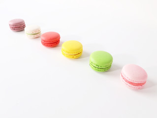 Colored macarons on white background