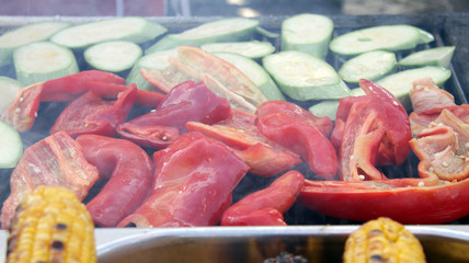 Fototapeta na wymiar Vegetables on a grill with steam. Veggies grilled on a barbeque. Vegetable pattern