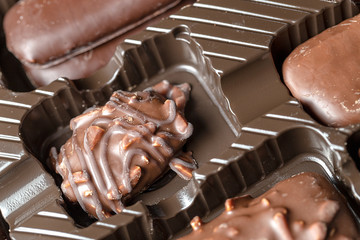 Appetizing food background. Assorted handmade candy in the box close up. Chocolate background. 