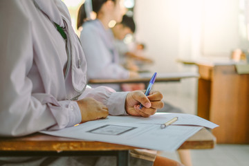 Student writing or taking test in classroom for midterm or final examination