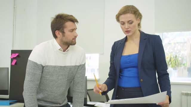 Engineer with scheme in hand discuss project of houses with workmate