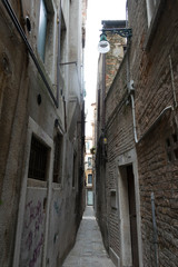 Fototapeta na wymiar Narrow street with colorful houses in the city of Venice