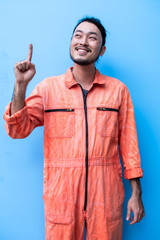Fototapeta premium A mechanic is point above for presenting something