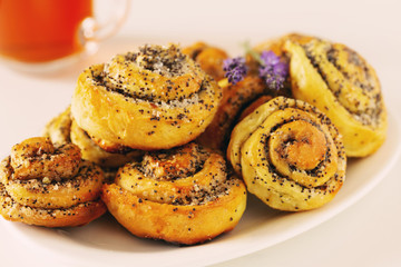 Homemade bun with poppy seeds and sugar, rolls on plate