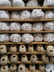 Cute animal dolls on orderly shelves in gift shop background