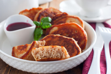Buckwheat pancakes on a white plate in jam, selective focus