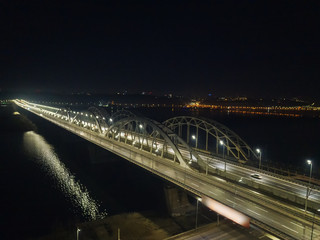 Busy traffic on the lantern-lit bridge of the night city.