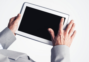 Hands of businessman holding tablet pc with black screen