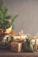 Christmas and zero waste, eco friendly packaging. Woman is wrapping gifts in craft paper on a...