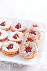 Traditional christmas linzer cookies on a white dish, selective focus