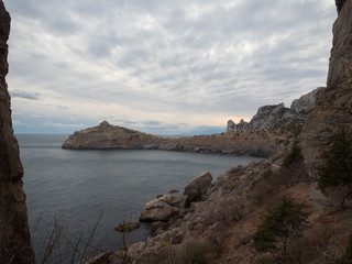 Fototapeta na wymiar Dolphin-shaped mountain cape. Autumn view of the sea coast of Crimea. Autumn landscape, beautiful mountains, sea in a cloudy day
