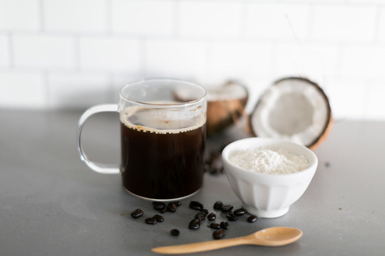 Cup of coffee with keto coconut creamer in white modern kitchen 