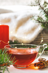 Cozy autumn  winter home, Christmas eve. Cup  tea, autumn garland on a wooden table near the bed with warm plaids. Autumn lifestyle lagom hygge.holiday and a weekend in the fall in winter on holidays.