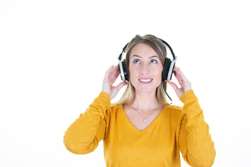 pretty blonde woman listening music in headphones and singing on white background looking up