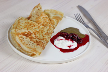  rum pancakes with sour cream raspberry sauce and pistachio paste for breakfast