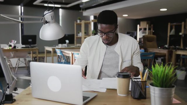 Tired African business man is closing notebook and lean back