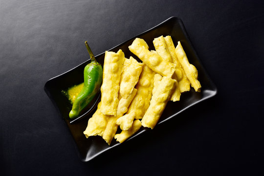 top view of fadra with green chilli on dark background