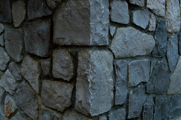 Corner of a wall lined with boulders