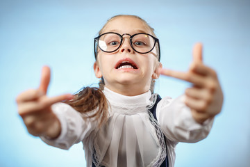 School Girl In Glasses Showing Middle Finger. An insulting gesture. A Bratty Child