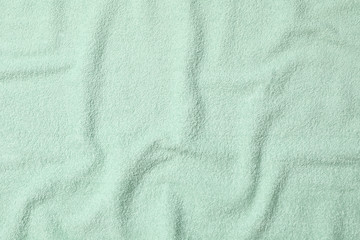 Fototapeta na wymiar Green towel textured background, close up and space for text