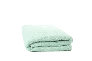 Folded green towel isolated on white background, close up