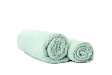 Rolled green towels isolated on white background, close up