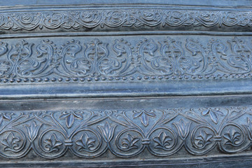 On the black, dark surface of the wall, various patterns are applied, an unusual background.