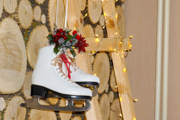New Year's and Christmas. Decorations in the form of real Skates for skiing against a background of rowan berries and a background of wood and stairs.