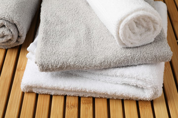 Obraz na płótnie Canvas White folded towels on bamboo background, close up
