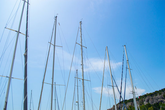 Masts of many yachts against the blue sky