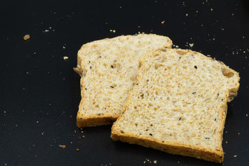 Fresh wheat bread slice isolated on black background.