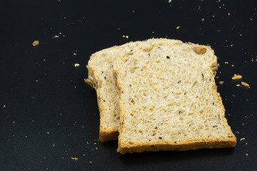 Fresh wheat bread slice isolated on black background.