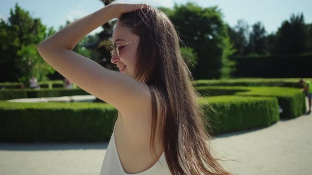 woman is walking in garden of famous Lednice castle