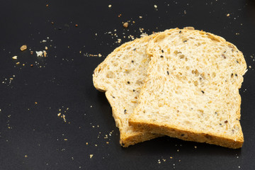 Fresh wheat bread slice isolated on black background.