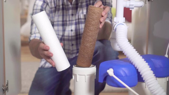 Plumber change the filter element in the water filter