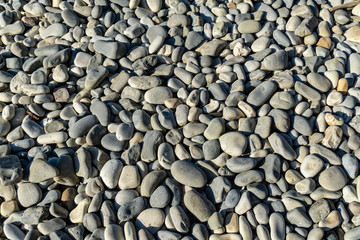 Sea pebbles as nature background. Beautiful sea stones of different sizes, texture and grey color. Excellent natural concept for any design. Calm landscape, fresh wallpaper, nature concept