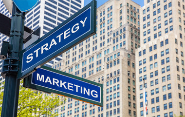 Obraz premium Strategy marketing crossroads street sign. Highrise buildings background,