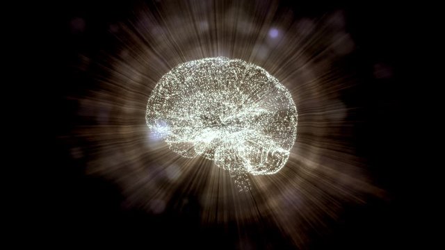 Abstract video of human brain in light rays and bokeh particles against black background.