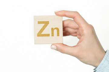 Doctor advises. Nutritionist or medical worker holds Zinc sign, healthy lifestyle concept.