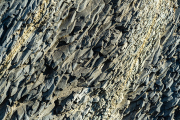 Beautiful natural texture of Caucasus mountains and rocks on the Black Sea coast in Olginka. Gray color. Selective focus