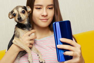 Girl makes selfie with a dog