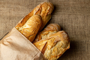French baguettes. Fresh crisp bread. Loaves in a paper bag.